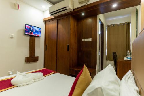 Ένα ή περισσότερα κρεβάτια σε δωμάτιο στο Royal Plaza Glitz Inn