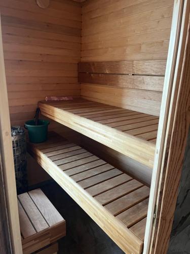 a wooden sauna with two bunk beds in it at Tamsalu Wallamaja in Tamsalu