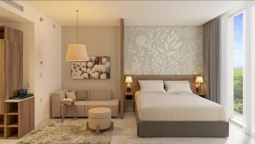a bedroom with a bed and a chair at Hyatt Place Cancun Airport in Cancún