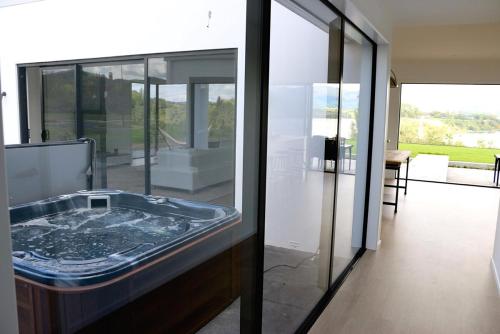 a bathroom with a tub in the middle of a room at Karapiro Lakeside in Karapiro