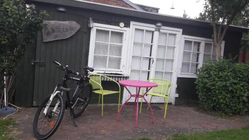 a table and chairs and a bike next to a house at bedandshower in Copenhagen