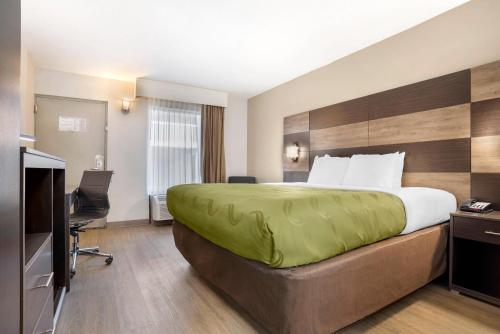 a hotel room with a bed and a television at Quality Inn Panama City North in Panama City