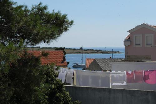 a group of laundry hanging on a clothesline in a city at Bed & Breakfast Novalja Inn in Novalja