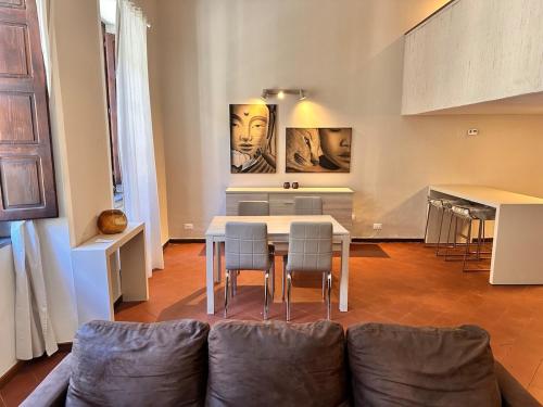 a living room with a couch and a table and chairs at glamour home arezzo in Arezzo