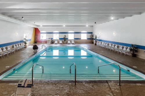 a large swimming pool with a person standing in front of it at Comfort Inn & Suites Event Center in Des Moines