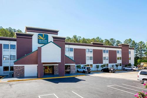 a hotel with a parking lot in front of it at Quality Inn & Suites near Six Flags East in Atlanta