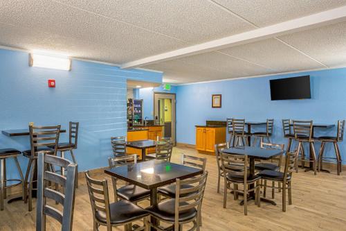 a dining room with tables and chairs and a tv at Quality Inn & Suites near Six Flags East in Atlanta