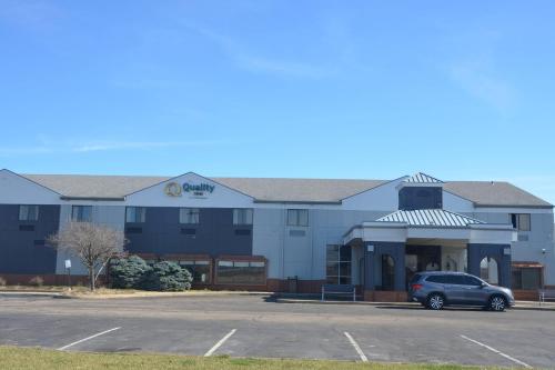 a building with a car parked in a parking lot at Quality Inn in Perrysburg