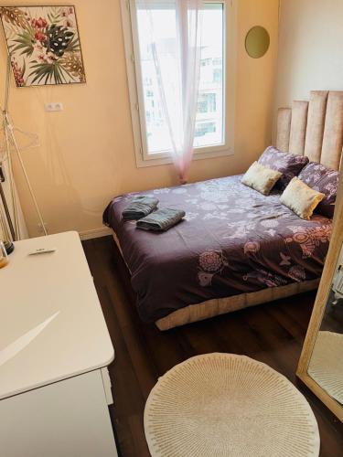 a small bedroom with a bed and a window at Rosewood Rooftop Eiffel Paris Porte de Versailles in Issy-les-Moulineaux
