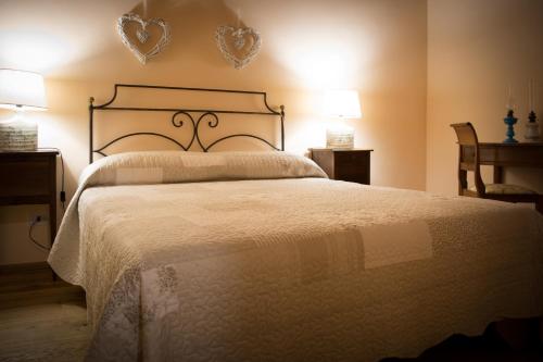a bedroom with a large bed with hearts on the wall at Da Titta in Pitigliano