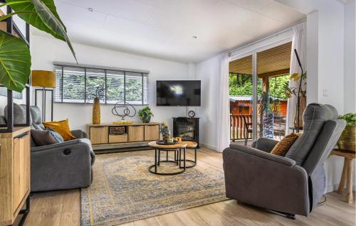 a living room with two couches and a tv at 1 Bedroom Stunning Home In Erm in Erm