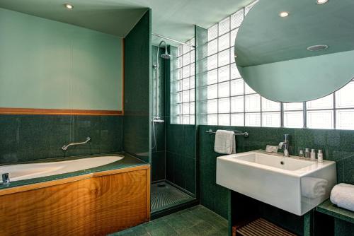 a bathroom with a bath tub and a sink at Towers Hotel Stabiae Sorrento Coast in Castellammare di Stabia