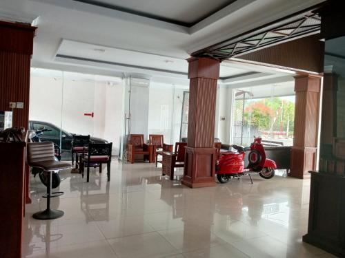 a lobby with a scooter parked in a room at Bugisan Iin Malioboro by Kawula stay in Mantaak