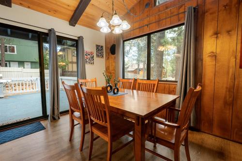 a dining room with a wooden table and chairs at Bear Woods 3BR Retreat in Big Bear City