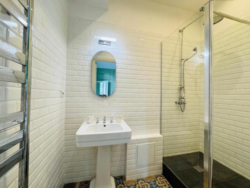 a white bathroom with a sink and a shower at Rooftop villa, city center, beach access in Nice