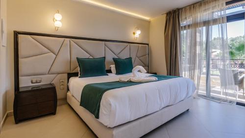 a bedroom with a large bed with a large window at Hotel Prestige Agadir Boutique & SPA in Agadir