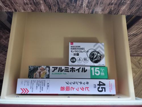 a shelf with three books in a box at 貸切ゲストハウス スポパー徒歩10分 Guesthouse near sports park in Naruto