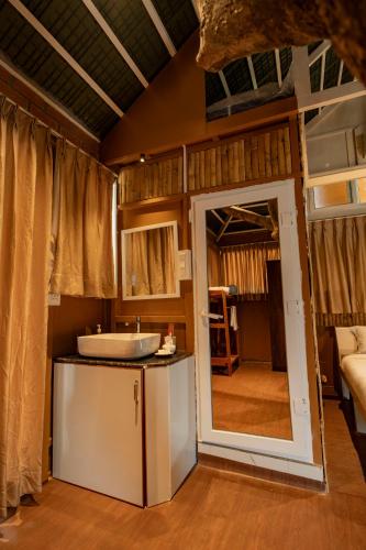 a bathroom with a sink and a tub in a room at Habba Dates Village Near Chikkaballapur in Bāgepalli