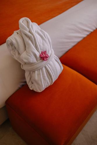 a white towel sitting on the corner of a bed at Hotel Prestige Agadir Boutique & SPA in Agadir
