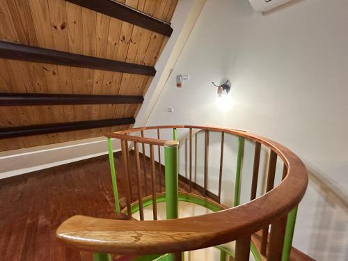 a wooden chair sitting in the middle of a staircase at 大方來富莊園民宿DF Life Lodge in Yongan