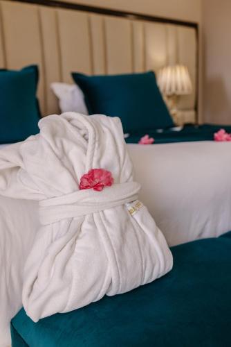 a white blanket sitting on top of a bed at Hotel Prestige Agadir Boutique & SPA in Agadir