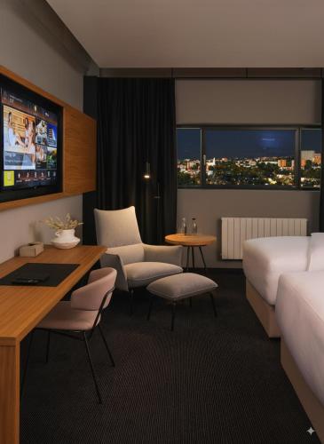 a hotel room with a bed and a table and chairs at Hotel Prior & Energy Spa in Zlín