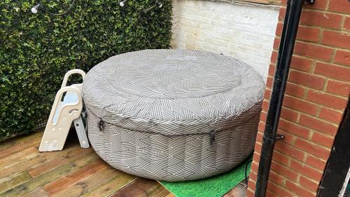 a large grey basket sitting on a wooden deck at Victorian Town House in the Heart of Dover in Dover