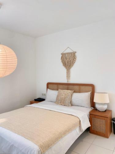 a bedroom with a bed and a lamp at Villa Tiella By The Villas 100 in Bogor