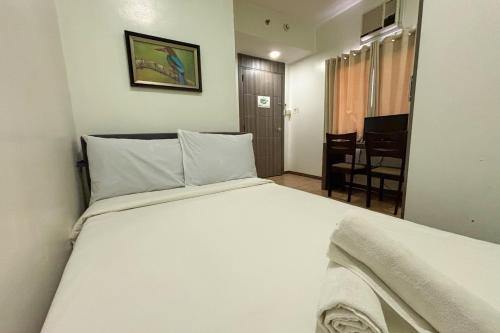 a bedroom with a large white bed in a room at Casa Lily Quezon City in Quezon City