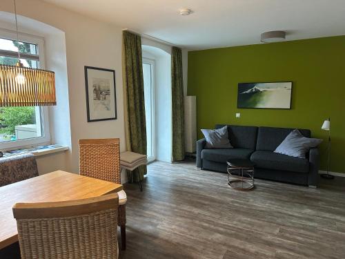 a living room with a couch and a table at Appartements Marlene in Maishofen