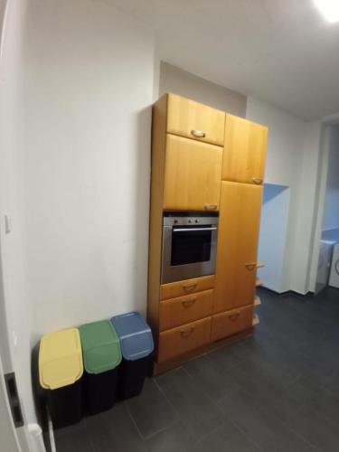a small kitchen with a cabinet and a oven at Zimmer am Hauptbahnhof 2 in Minden