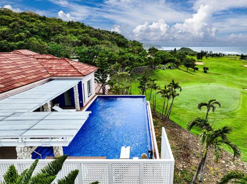 an aerial view of a house with a swimming pool at The Shigira in Miyako Island