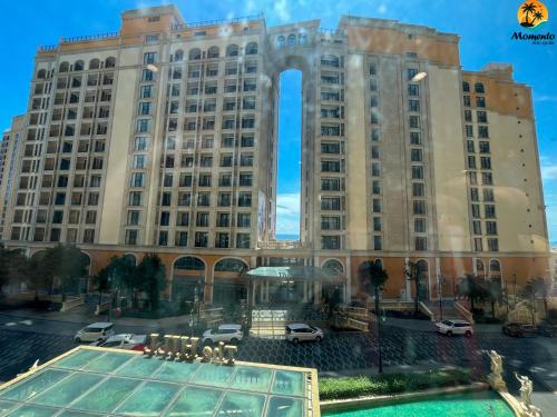 a large building with a pool in front of it at Sunset town Phú Quốc in Phu Quoc
