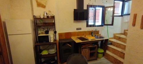 a small kitchen with a sink and a stove at Casa abuelo Kalinas in Cazorla