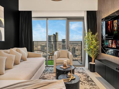 a living room with a white couch and a large window at SmartStay at Burj Royale - Unique Downtown Dubai City Views - Brand New Luxury Apartments in Dubai