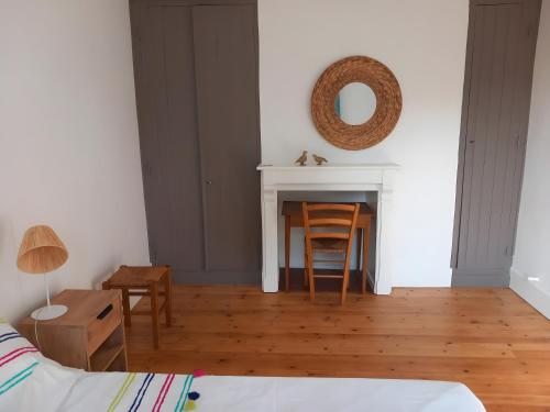 a living room with a table and a fireplace at Gîte Du Briquet D'artois in Domqueur