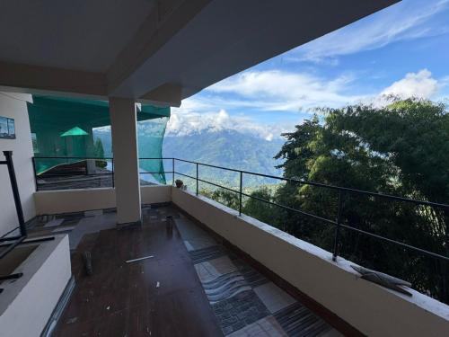 a balcony of a house with a view of mountains at Tibet Home pelling in Pelling
