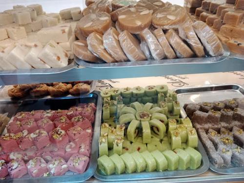 a display case with different types of donuts and pastries at Food Qila Hotel & Guest House in Dargai