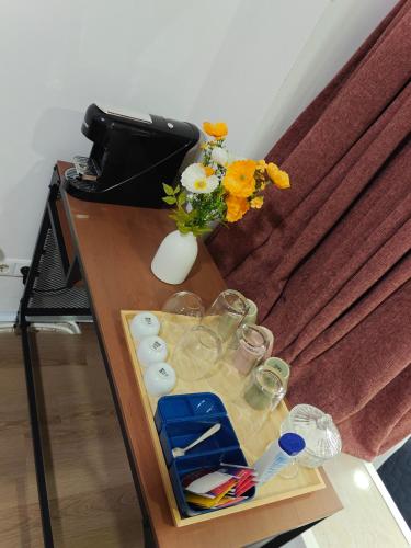 a table with glasses and a vase with flowers on it at Eastern in Tilburg