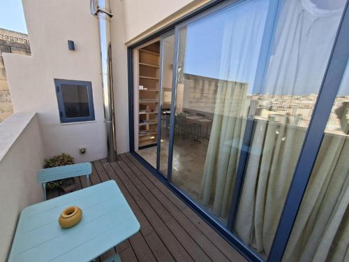 a balcony with a bench and a large window at Medieval Knights house GF with Seaview at the Three Cities Marina in Senglea