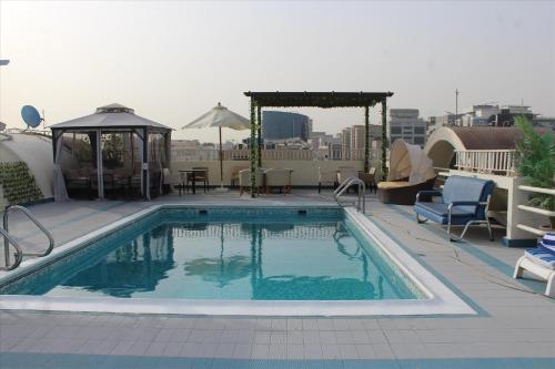 a swimming pool on the roof of a building at Al Khaleej Palace Deira Hotel in Dubai