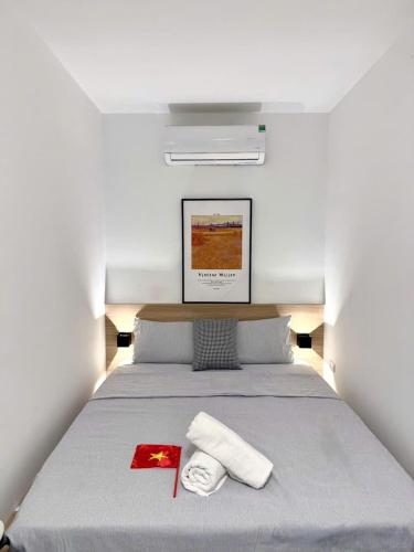 a bedroom with a bed with two towels on it at Chez Lumi Hotel in Hanoi