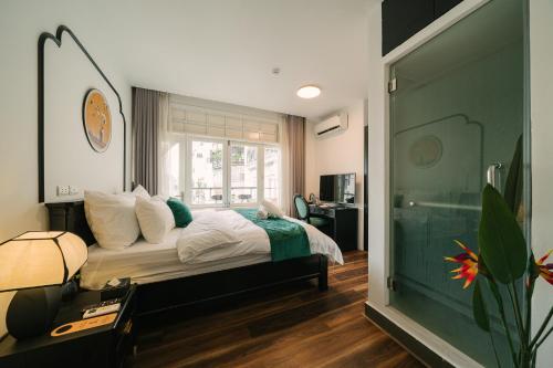 a bedroom with a bed and a large window at Chez Lumi Hotel in Hanoi