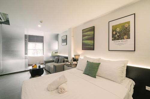 a bedroom with a bed and a living room at Chez Lumi Hotel in Hanoi
