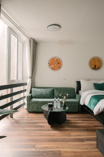 a living room with a couch and a coffee table at Chez Lumi Hotel in Hanoi