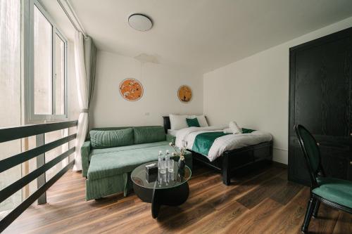 a living room with a bed and a couch at Chez Lumi Hotel in Hanoi
