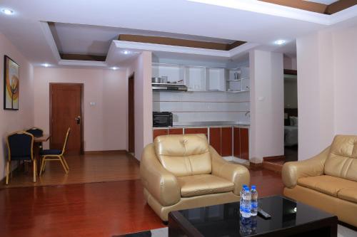 a living room with two chairs and a table at Yinm Guest house in Addis Ababa