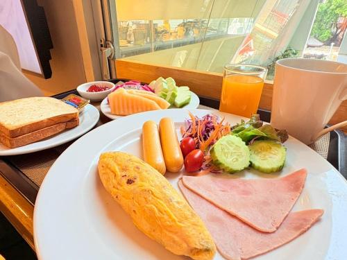 a plate of food with meat and vegetables on a table at I Residence Hotel Silom in Bangkok