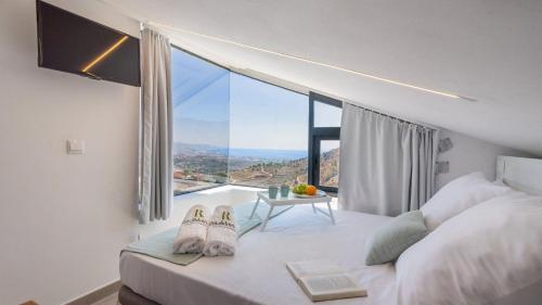 a bedroom with a bed with a large window at Villa Alborada Torrox by Ruralidays in Torrox