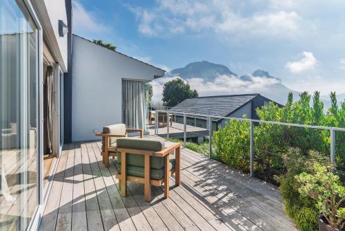 a balcony with a view of a house at Clouds Estate in Stellenbosch